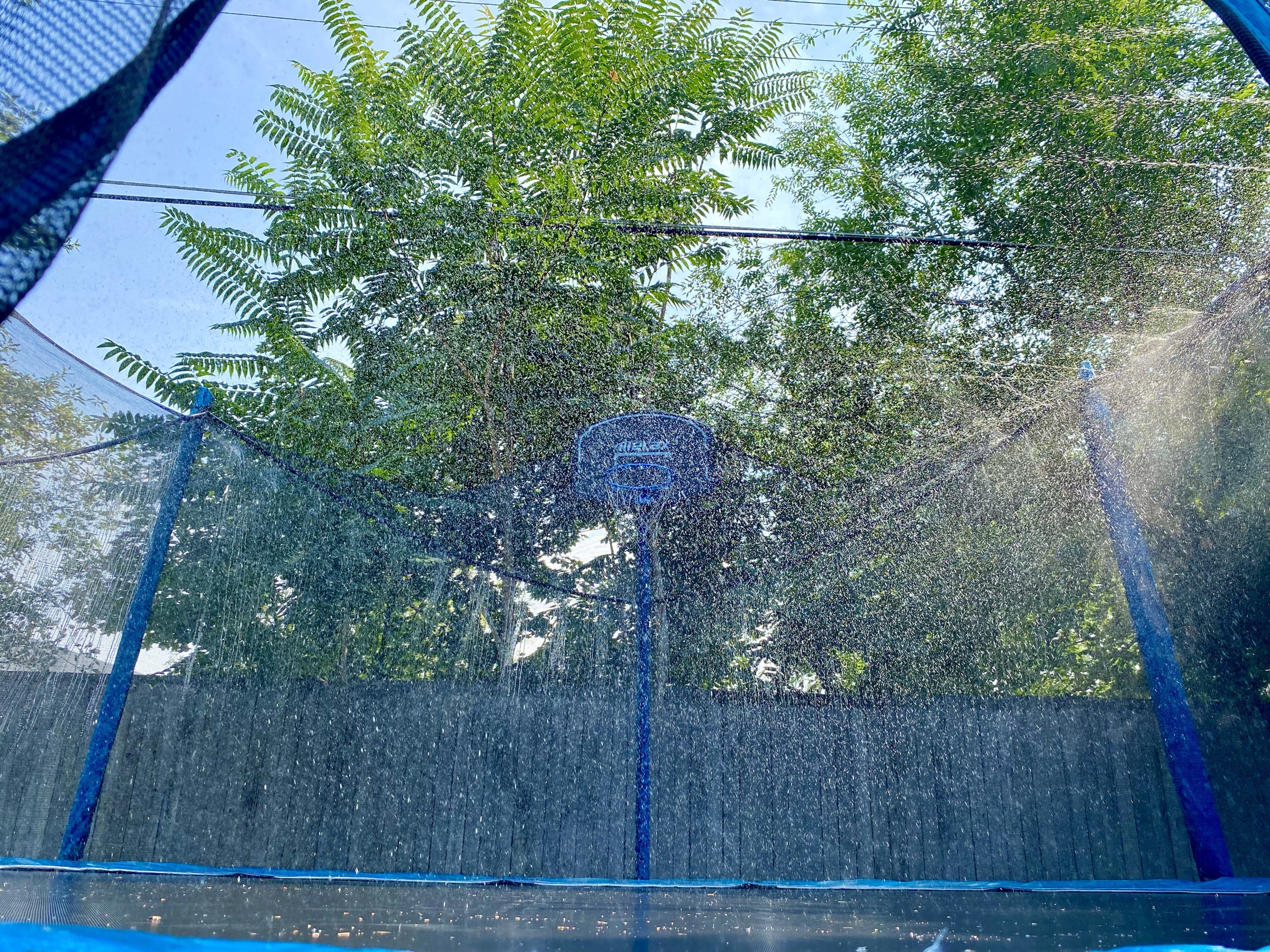 Water park feature and basketball hoop inside the trampoline
